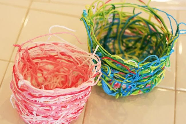 Small baskets made of colorful yarn stiffened with glue (First Grade Art)