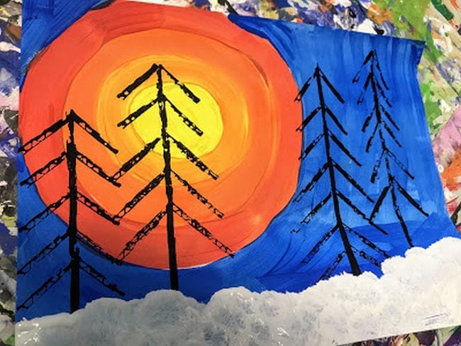 Painting of large yellow and orange sun on a blue sky with snow and bare black trees