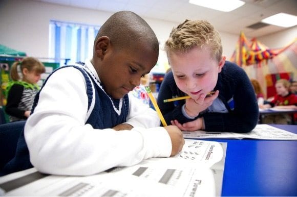 Two students working together on a worksheet