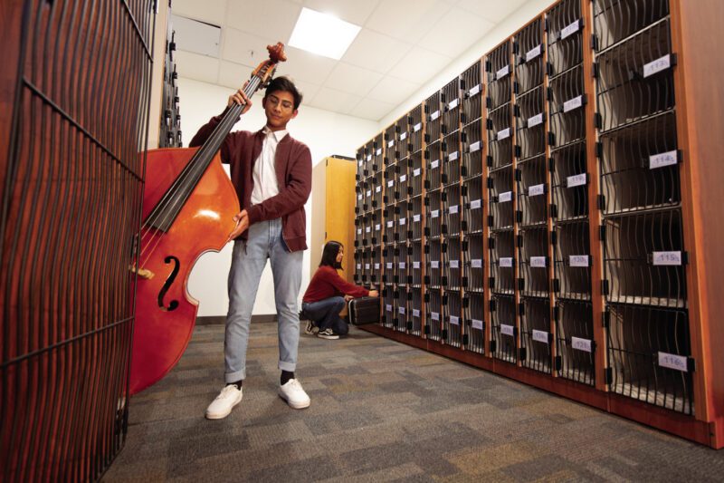 High school student taking cello out of Acousticabinets