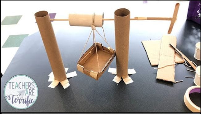 Elevator made of paper towel tubes, dowel rods, and string