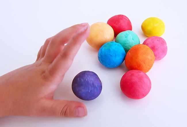 Student's hand bouncing colorful homemade balls (Fifth Grade Science)