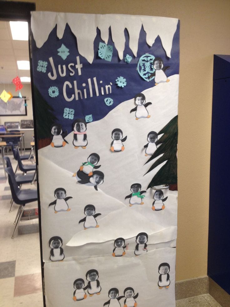 Classroom door decorated to look like a snowy slope, with penguins with pictures of students' faces (Winter Classroom Doors)
