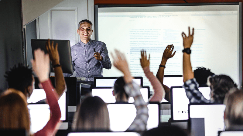 Teacher leading students in technology lesson to show that AI won't kill education
