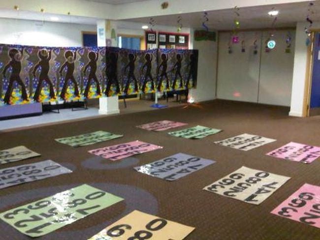 Large mats with the numbers 0 to 9 laid out on the floor