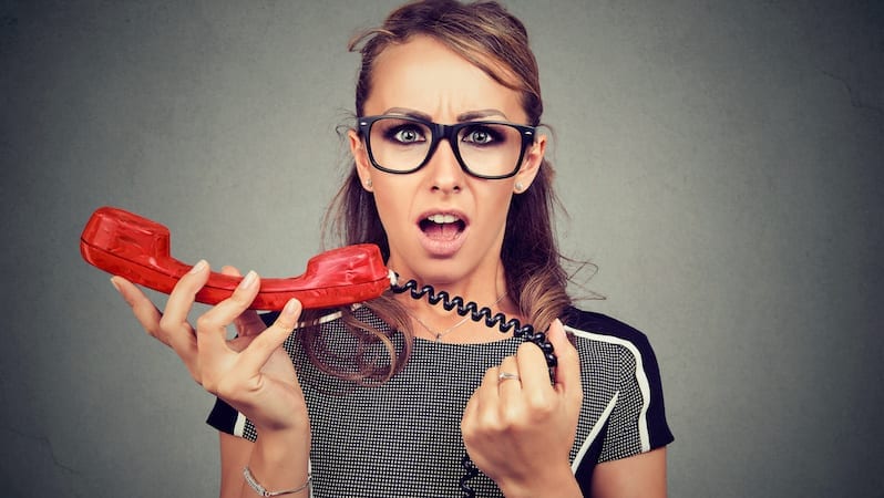 Shocked woman receiving bad news on the phone