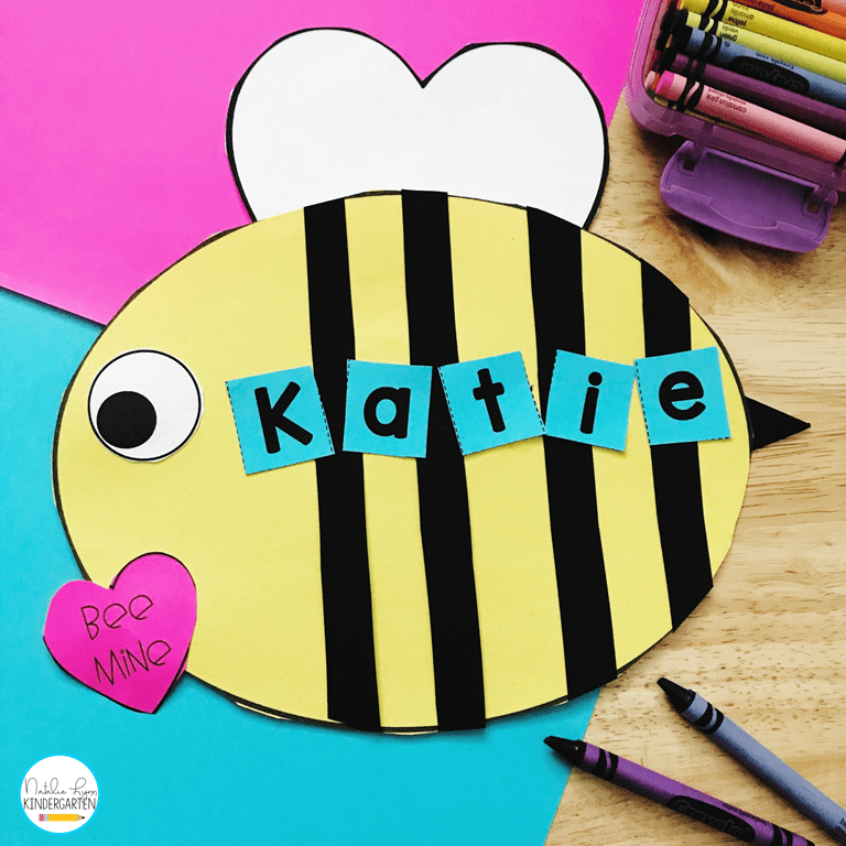 A bee is made from card stock.  It has a pink heart on it that says Bee Mine.  The name Katie is spelled out across the bee's body (Valentine's Day Crafts for Preschoolers)