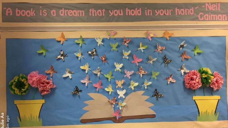 Bulletin board showing colorful butterflies emerging from an open book. Text reads 