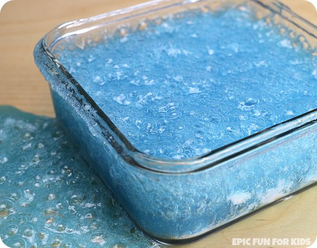 a pyrex pan filled with bright blue bubbling slime