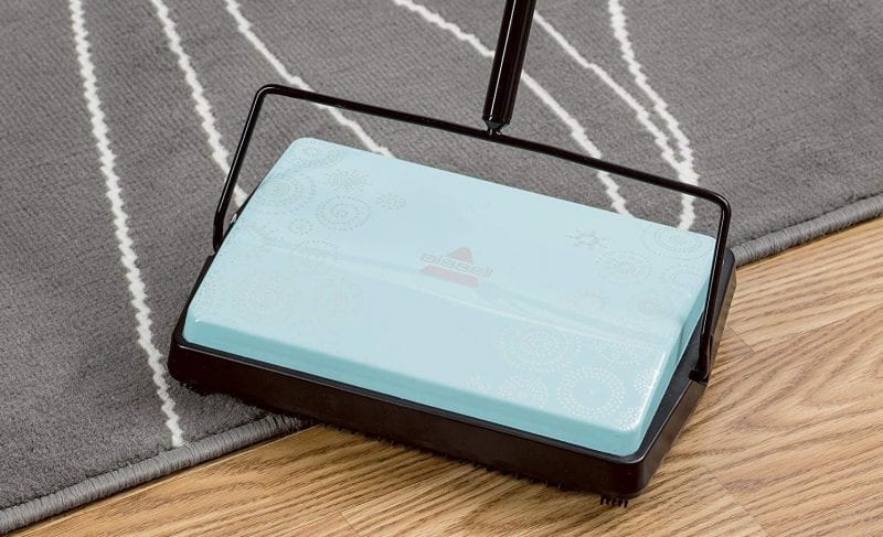 Blue and black carpet sweeper, as an example of classroom cleaning supplies