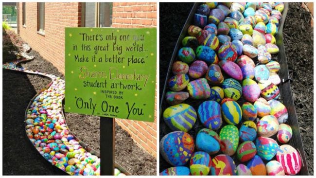 Painted rocks arranged to form a flowing river shape with a sign saying There's Only One You (Collaborative Art Projects)