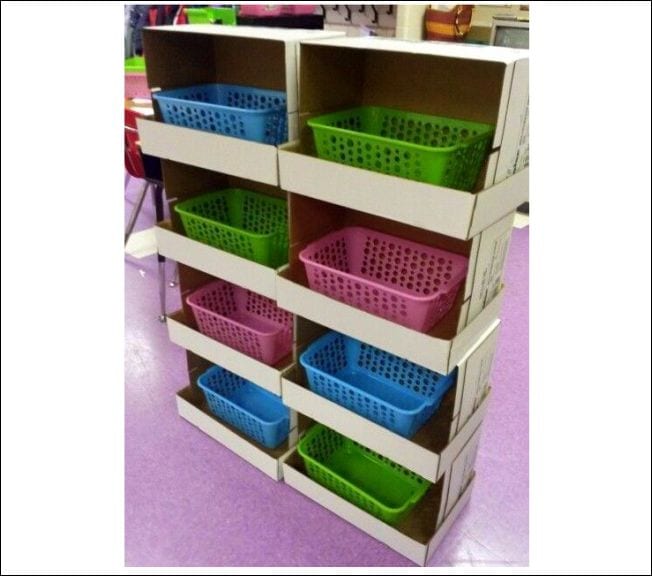 Cardboard boxes stacked with lids turned sideways to form bins for plastic baskets