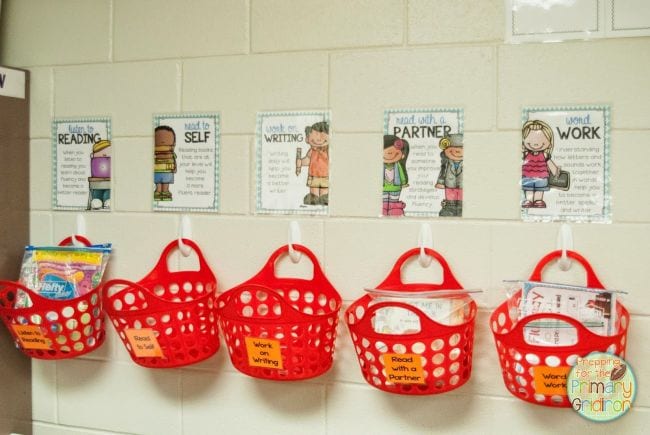 Red plastic basket totes hung from Command hooks and used as DIY cubbies