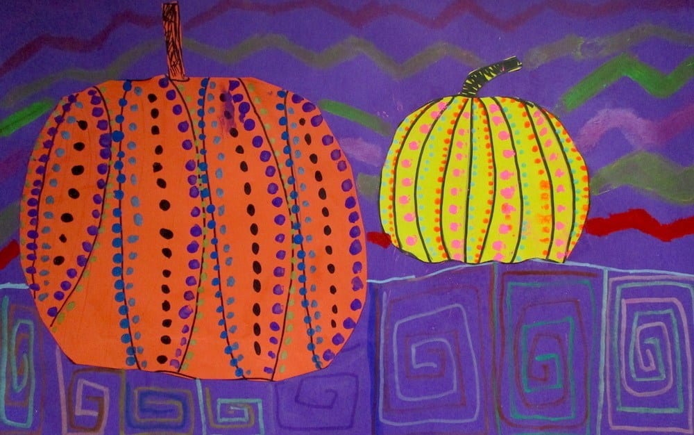 Orange and yellow construction paper pumpkins with dotted patterns on purple background