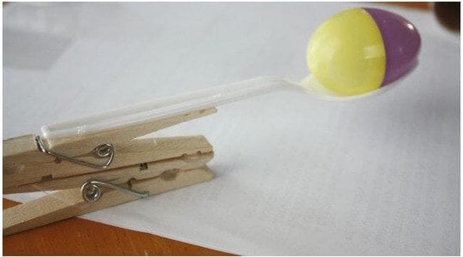 Egg launcher for plastic eggs made of a clothespin and plastic spoon