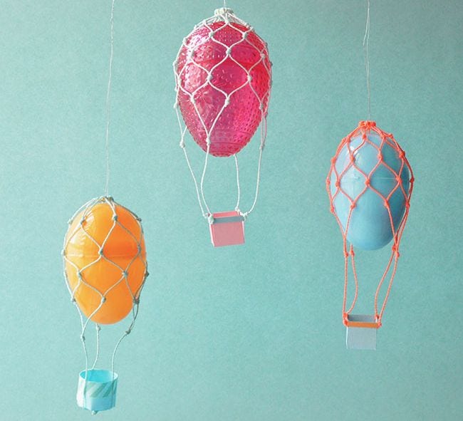 Plastic Easter eggs turned into hot air balloons with string and paper baskets