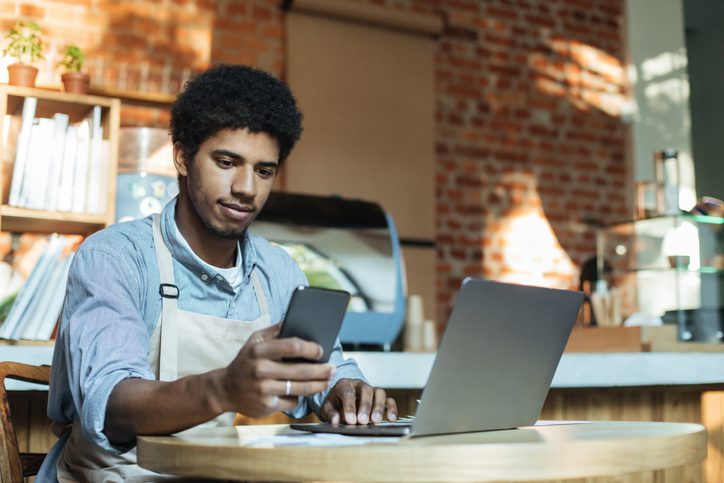 Young black man working on laptop for business, , as an example of interactive career exploration activities