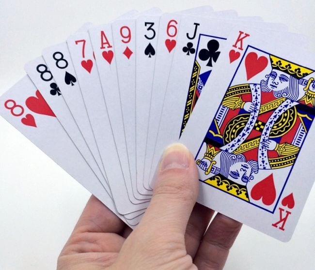A hand holding playing cards 