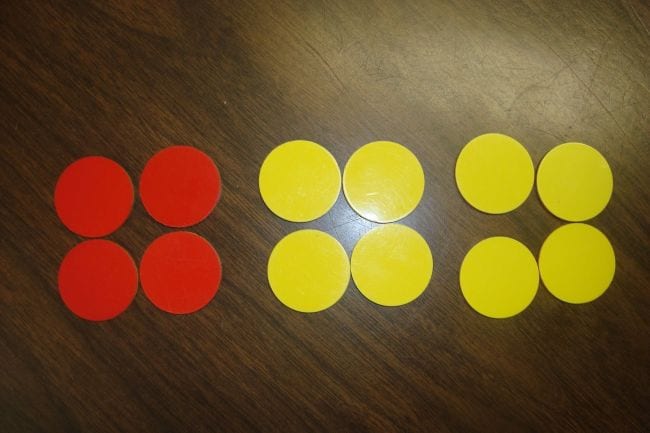 Red and yellow counters laid out in groups of four
