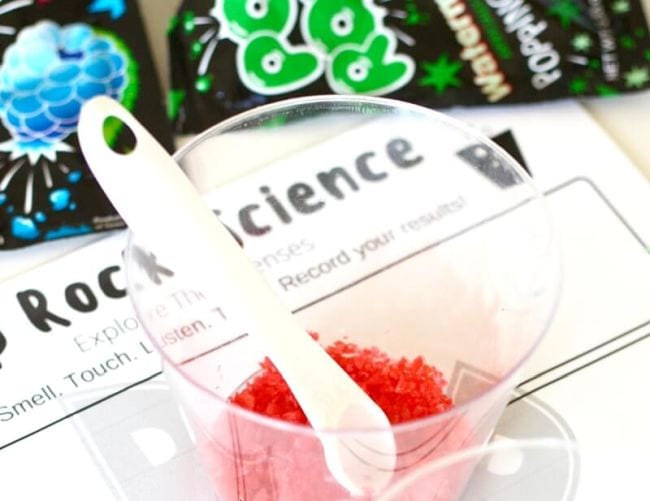 Plastic cup of red Pop Rocks with a small spoon and Pop Rocks Science workseet