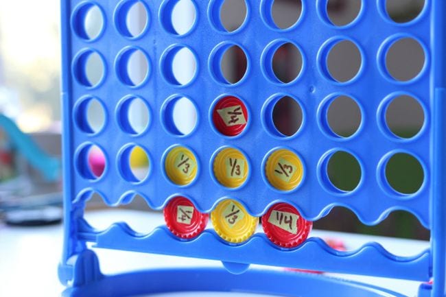 Connect Four game with fractions written on the checker game pieces (Fraction Games)