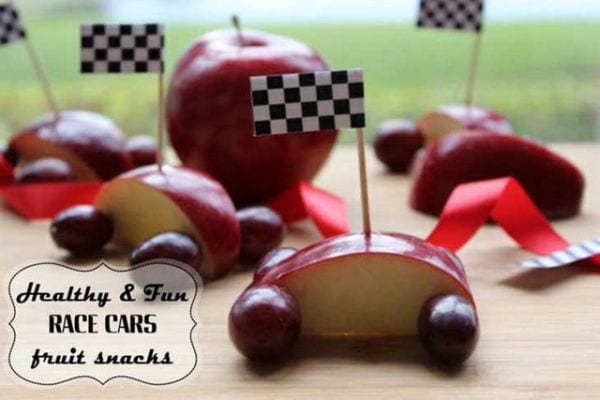 Apple slices with grape wheels and checkered flag toothpicks
