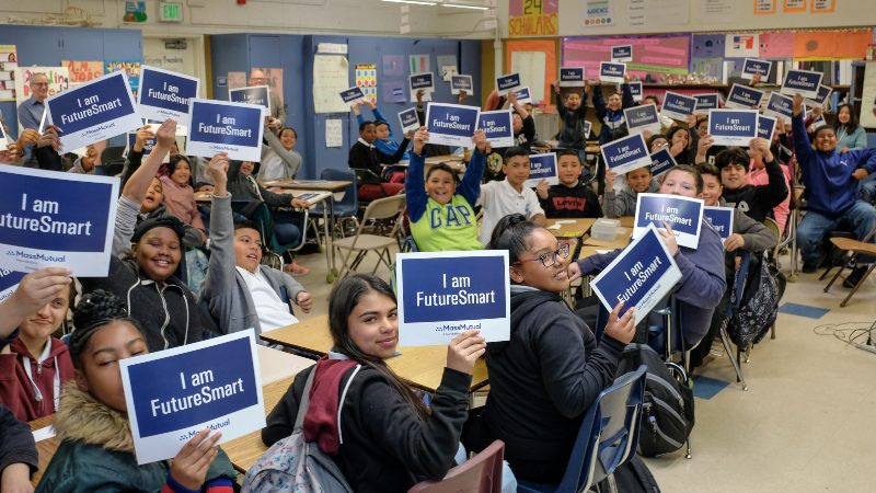 students in large classroom holding I am FutureSmart signs