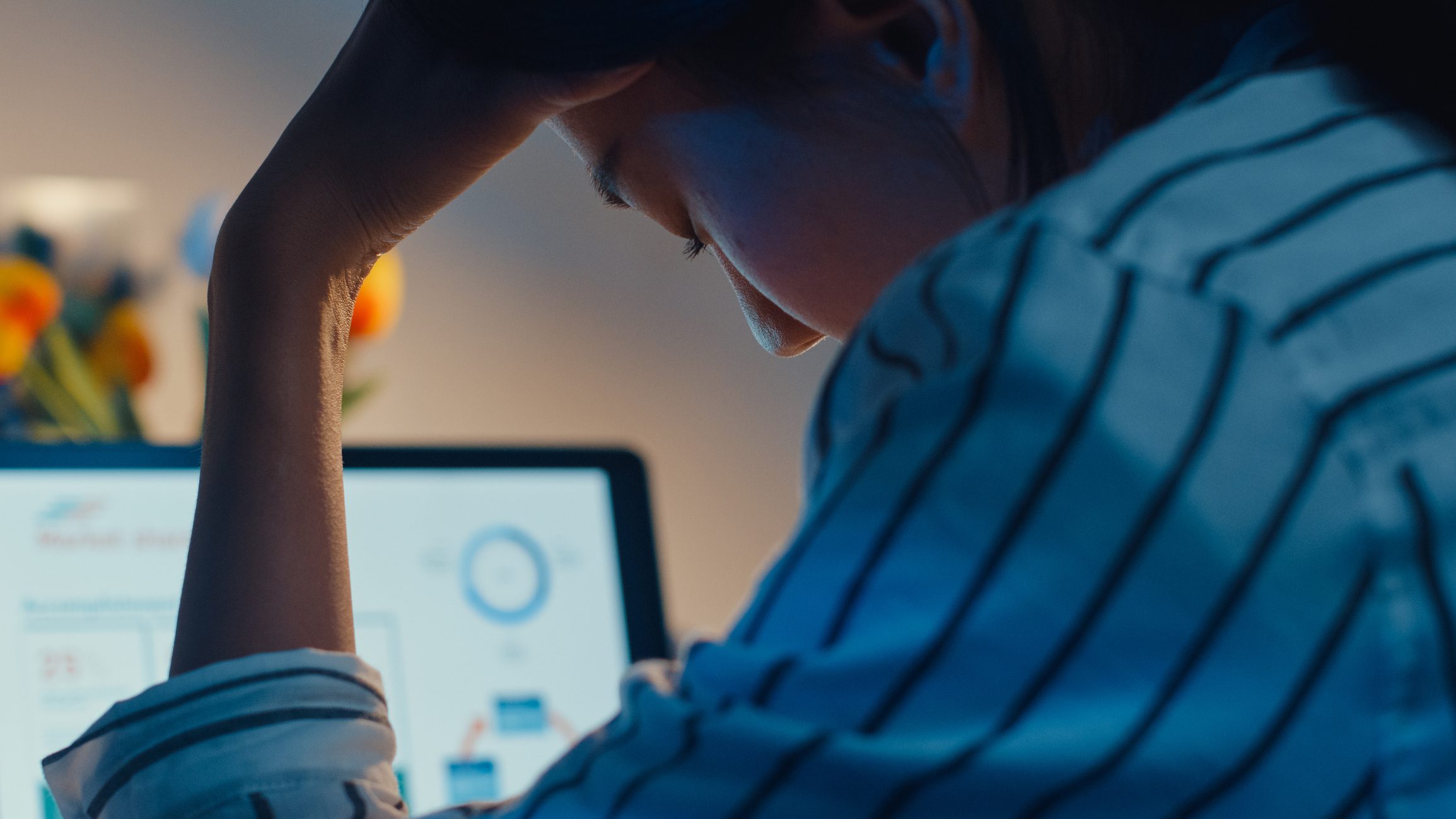 Photo of teacher stressed in front of laptop