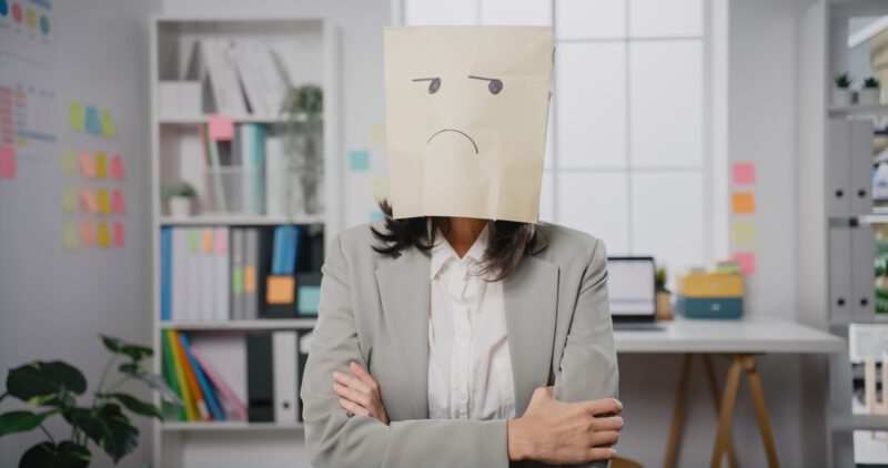 Woman with bag on head unhappy about wearing hard clothes