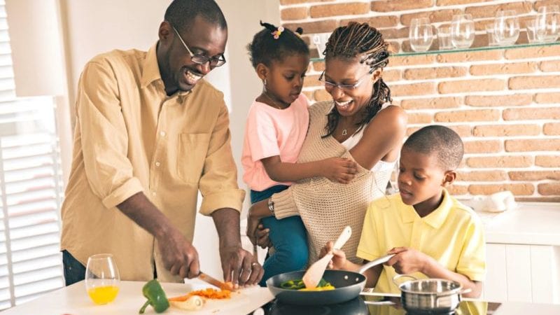 African American family cooking dinner together