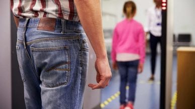 Passenger Passing Through Security Check At Airport - In Defense of School Metal Detectors