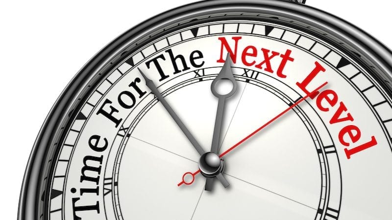 Time for the next level red word on concept clock, isolated on white background