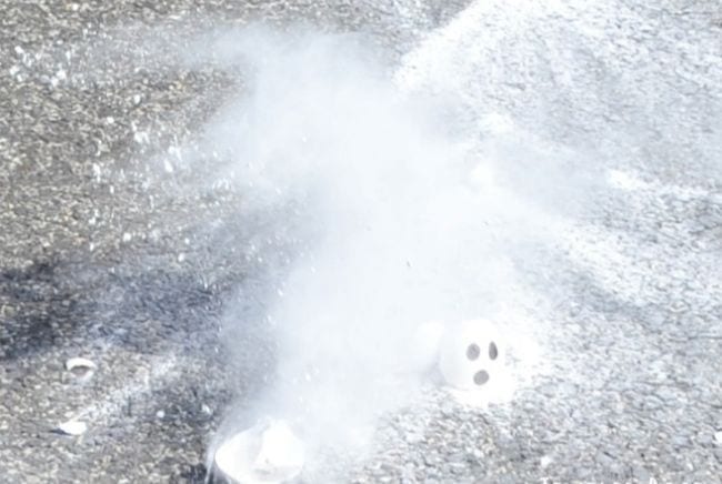 Eggshell painted with ghost eyes, dropped on the sidewalk in a cloud of cornstarch (Halloween Activities)