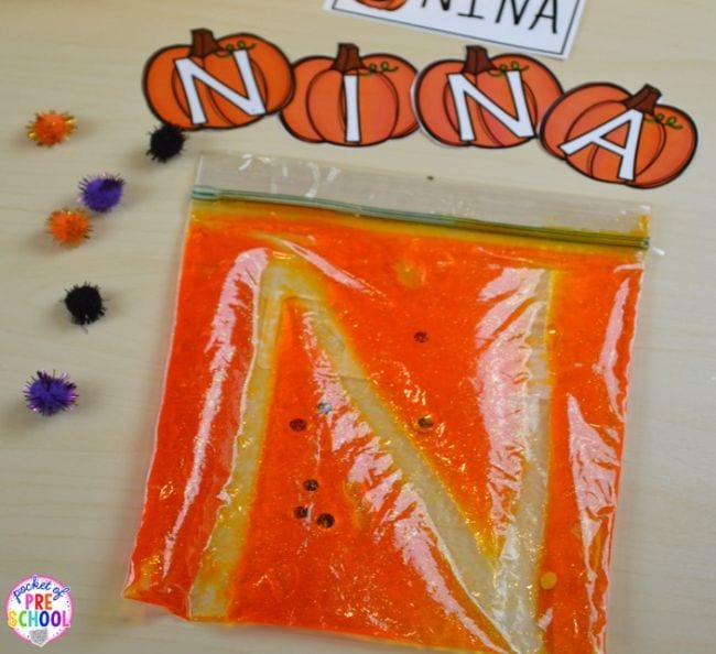 Plastic zipper bag filled with bright orange gel with the shape of an N traced in it.
