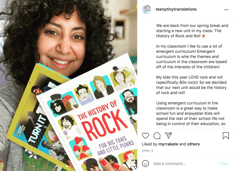 A woman with curly hair and a large smile holds up two novels, one of them titled "The History of Rock for Big Fans and Tiny Punks"