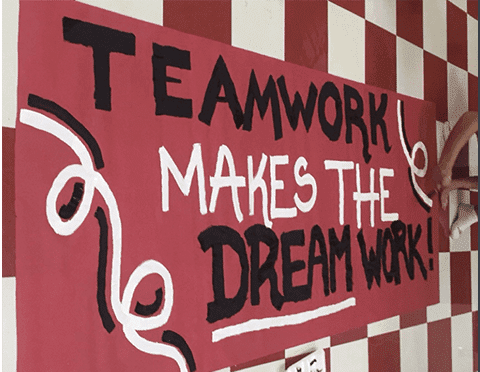 A red and white school spirit poster.