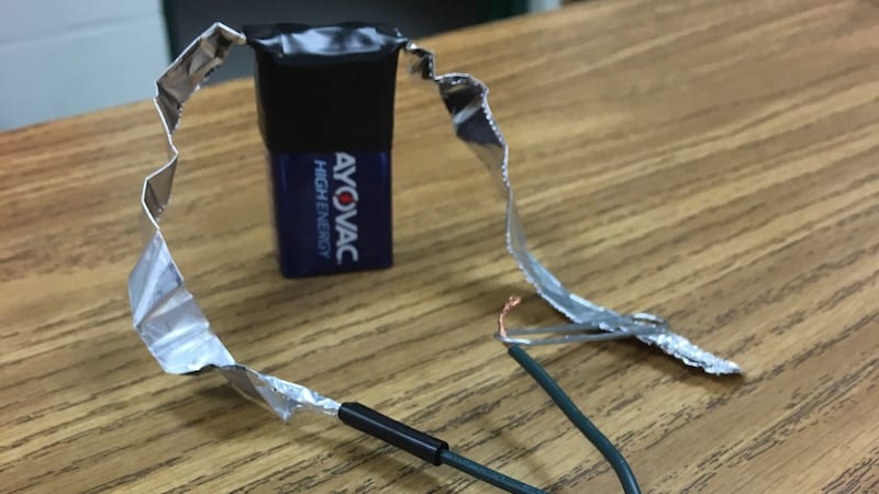Electricity experiment using a battery and tinfoil with wires.