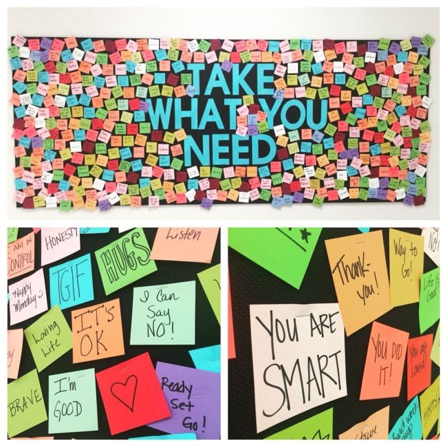 Take What You Need bulletin board with encouraging notes posted on it for other students to take