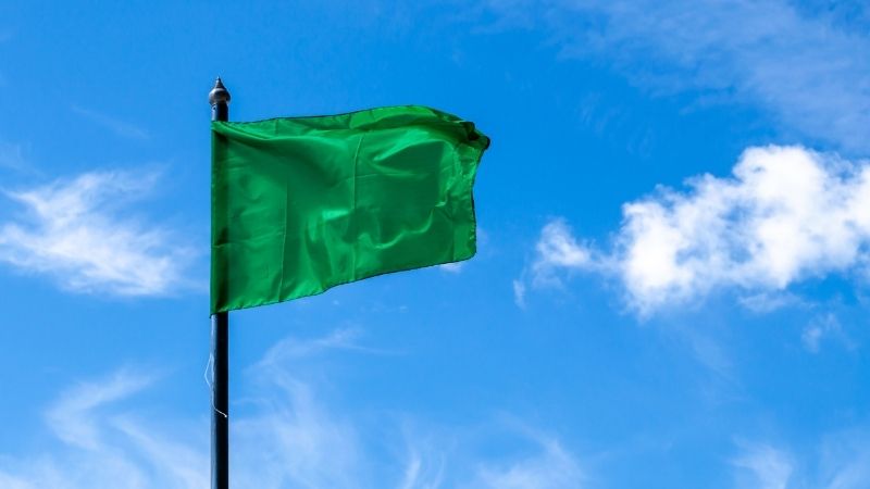 Green flag against blue sky