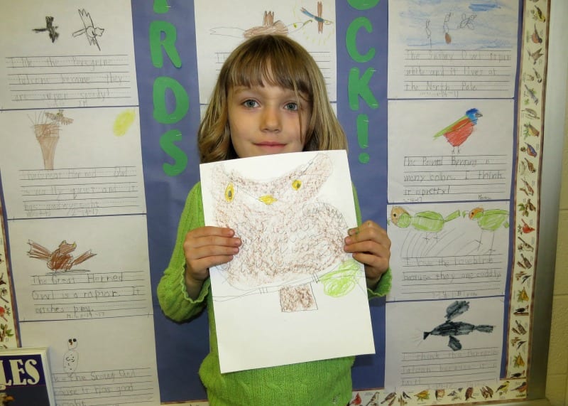 Student holding up a drawing