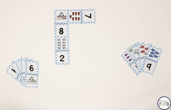 Paper dominos with number on one side and variety of penguins, fish, or other items on the other