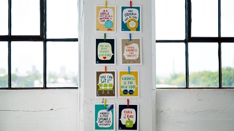 Kindness Posters hanging on a pillar between two windows (Inexpensive Gift Ideas for Students)