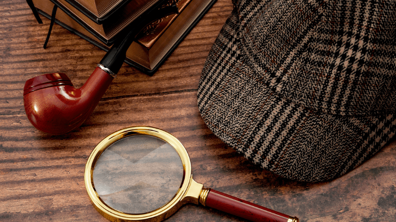 Literary fiction, police inspector, investigate crime and mystery story conceptual idea with sherlock holmes detective hat, smoking pipe, retro magnifying glass and book isolated on wood table top - s