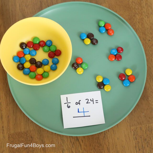 a yellow bowl of M&Ms on a green plate