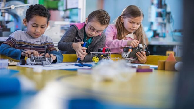children working in a classroom makerspace, as an example of indoor recess ideas