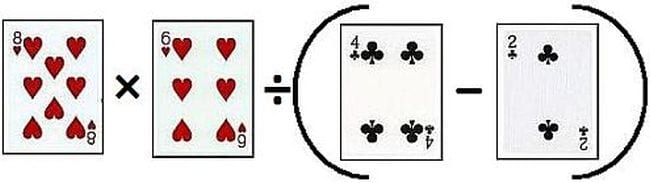 Playing cards laid out to create a math equation with multiplication, division, and parentheses