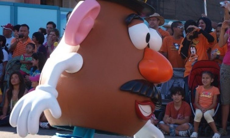 Lifesize Mr. Potato Head costume performing for crowd, as an example of SEL activities