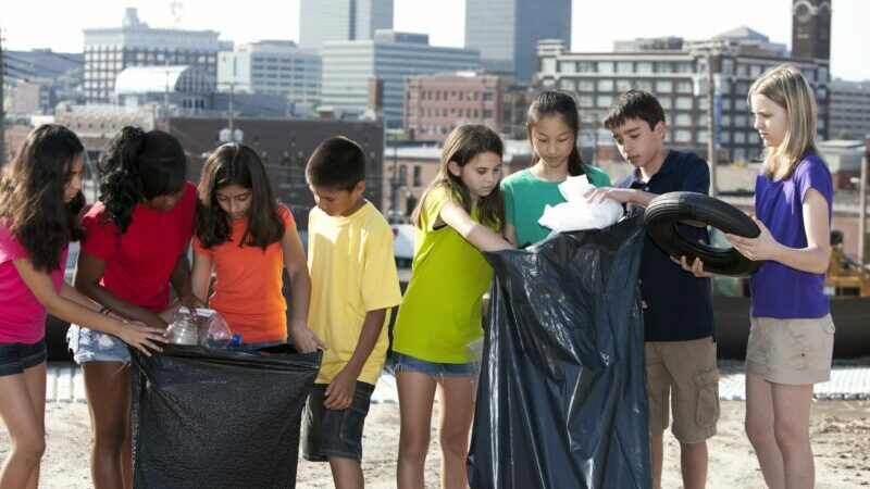 either diverse students working on a rooftop garden together