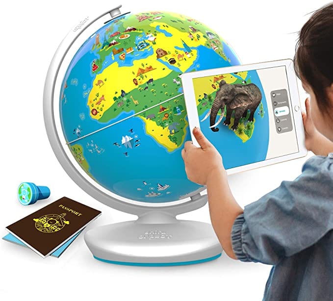Child playing with interactive globe, as an example of educational toys for first grade