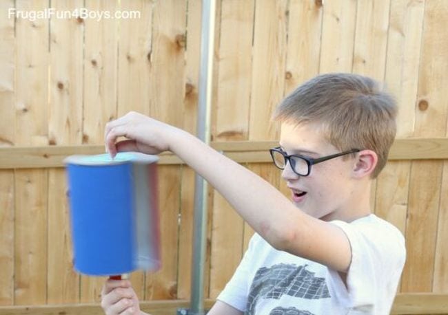 Student holding a homemade wind turbine (Outdoor Science)